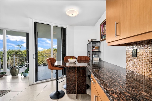 dining space with light tile floors and floor to ceiling windows