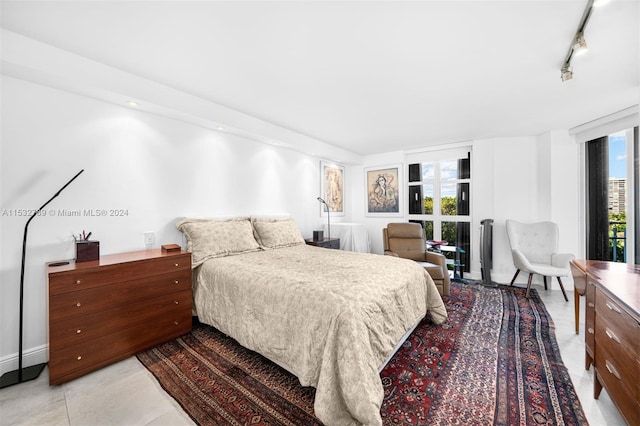 tiled bedroom featuring track lighting