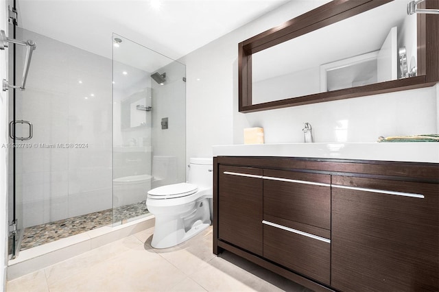 bathroom with tile floors, walk in shower, toilet, and vanity