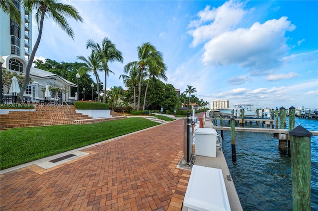 dock area with a yard and a water view