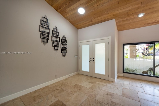 tiled foyer featuring wood ceiling, lofted ceiling, and french doors