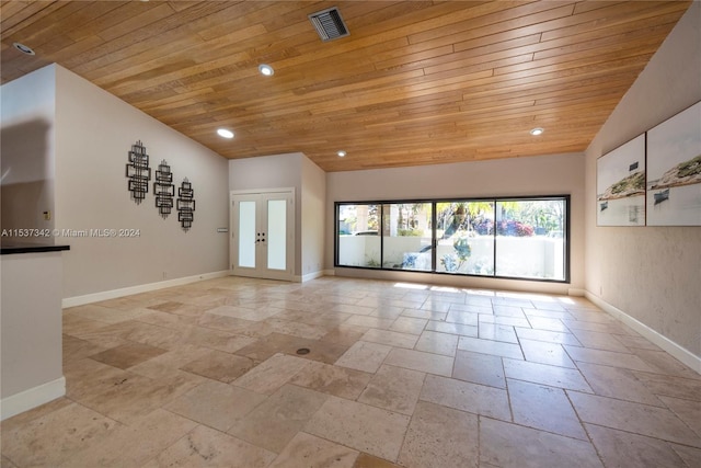 interior space with light tile floors, lofted ceiling, french doors, and wooden ceiling