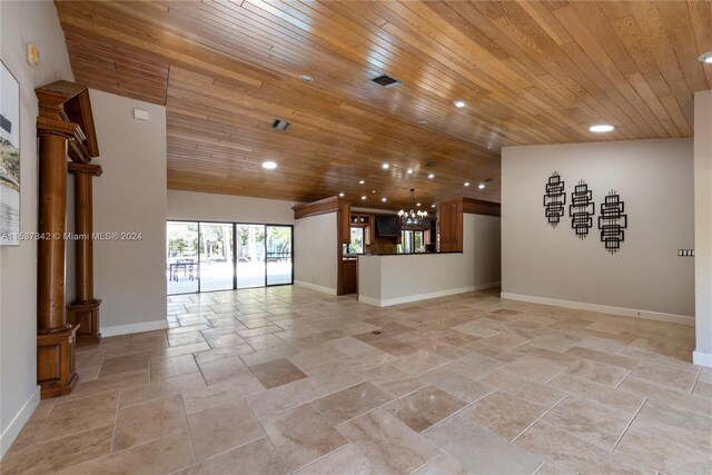 unfurnished living room with light tile floors, wood ceiling, and a chandelier