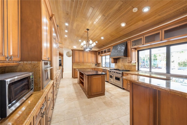 kitchen featuring premium range hood, stainless steel appliances, a notable chandelier, a center island, and tasteful backsplash