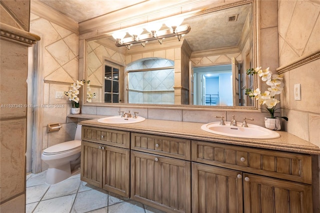 bathroom featuring crown molding, toilet, and tile walls