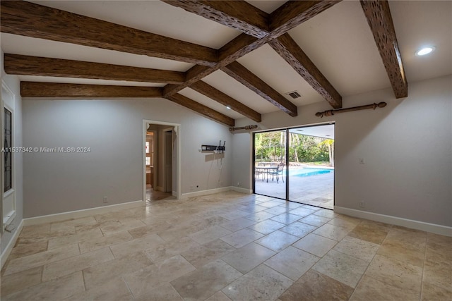 tiled empty room with vaulted ceiling with beams