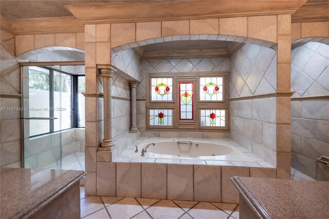 bathroom with tile floors and a relaxing tiled bath