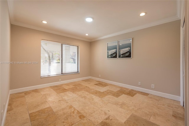 unfurnished room with crown molding and light tile floors