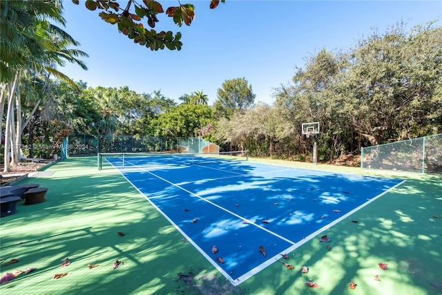 view of tennis court with basketball hoop