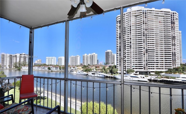 balcony with a water view and ceiling fan