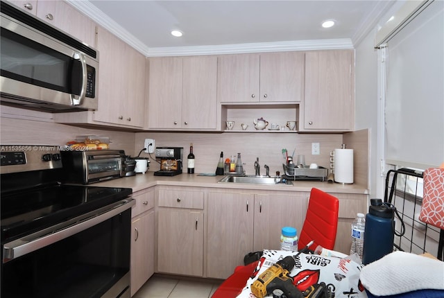 kitchen with appliances with stainless steel finishes, sink, light brown cabinetry, crown molding, and light tile patterned floors