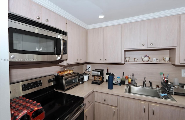 kitchen with light brown cabinetry, sink, crown molding, and stainless steel appliances