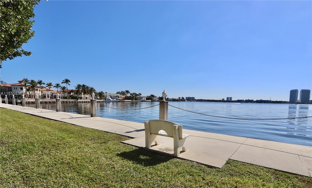 view of dock featuring a water view and a lawn