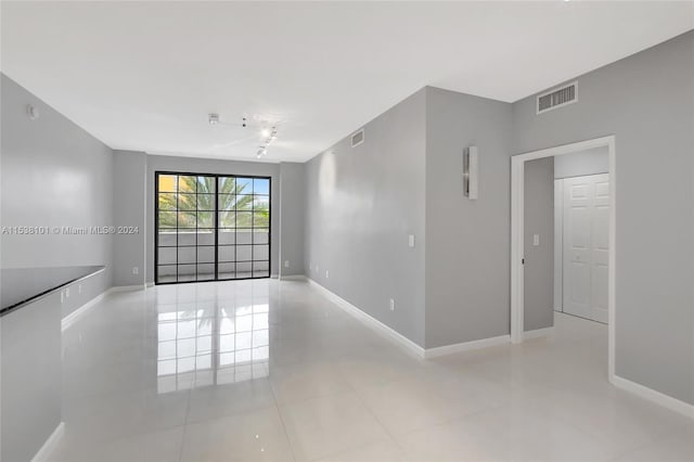 spare room featuring light tile floors