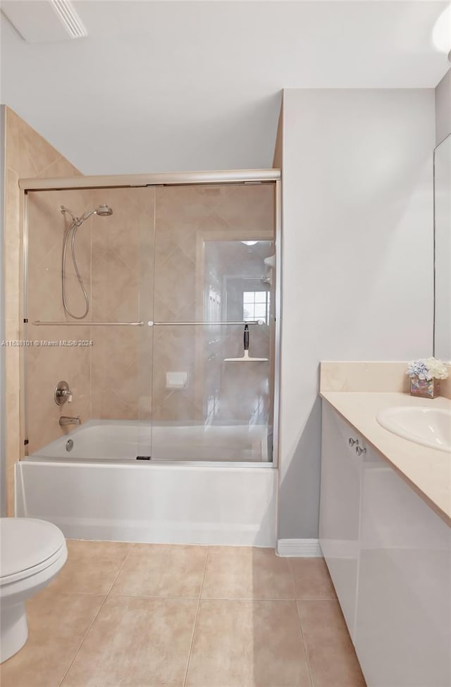 full bathroom with toilet, combined bath / shower with glass door, tile floors, and vanity