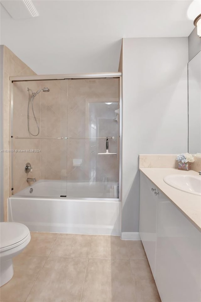 full bathroom featuring toilet, combined bath / shower with glass door, tile floors, and vanity