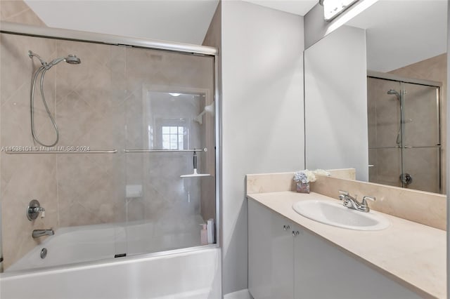 bathroom featuring vanity and bath / shower combo with glass door