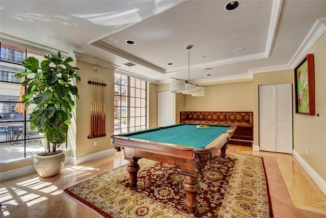 playroom with pool table, a tray ceiling, and ornamental molding