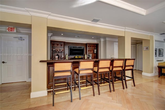 bar with light parquet flooring and ornamental molding