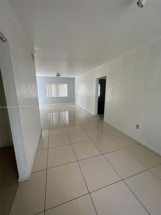 hall with light tile patterned flooring