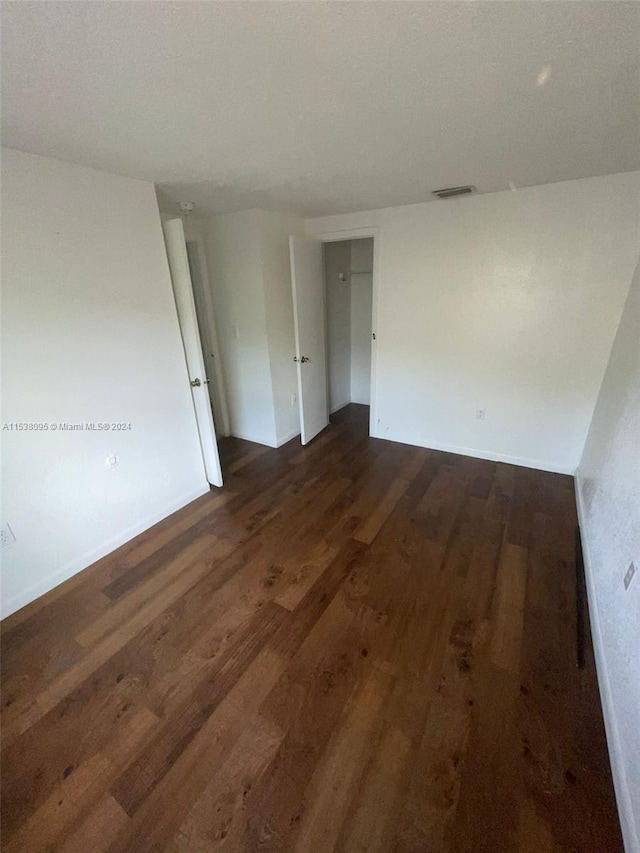 spare room featuring dark hardwood / wood-style flooring