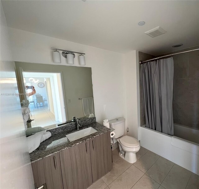 bathroom with vanity, tile patterned flooring, shower / bath combination with curtain, toilet, and visible vents