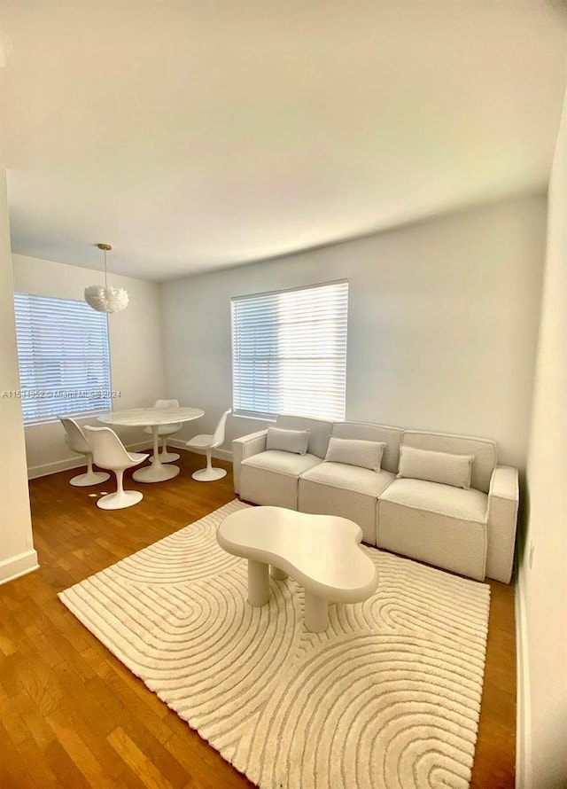 living room featuring hardwood / wood-style floors and a chandelier