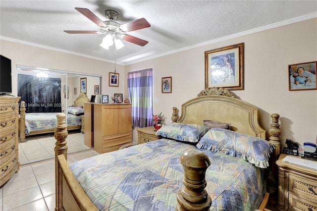 tiled bedroom featuring crown molding, a closet, and ceiling fan