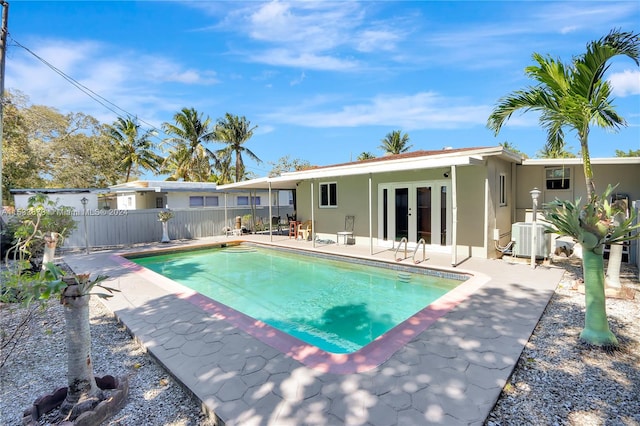 view of pool featuring a patio, french doors, and central air condition unit