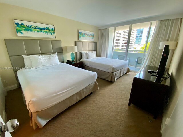 bedroom featuring access to outside and carpet flooring