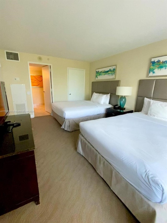 bedroom featuring light carpet