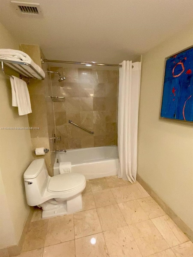 bathroom featuring shower / bath combination with curtain and toilet