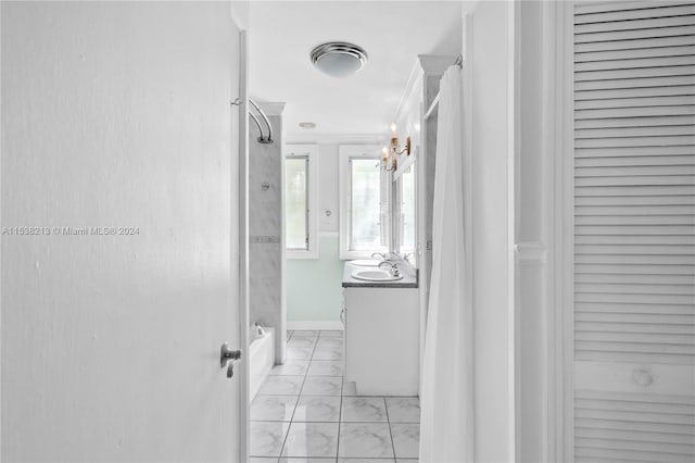 hall featuring a notable chandelier, sink, and crown molding