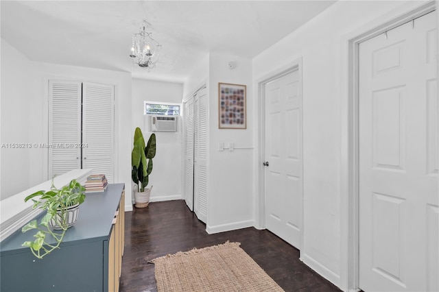 entryway featuring dark hardwood / wood-style flooring, cooling unit, and a chandelier