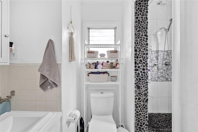 bathroom with a tile shower and toilet