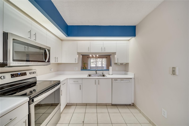 kitchen featuring sink, light tile patterned floors, white cabinets, and appliances with stainless steel finishes