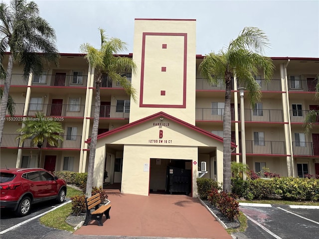 12755 SW 16th Ct Unit 211B, Pembroke Pines, FL 33027 - view of apartment building / complex with uncovered parking