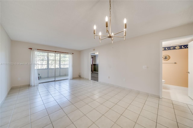 tiled empty room with a notable chandelier