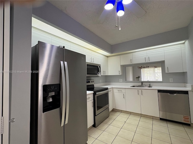 12755 SW 16th Ct Unit 211B, Pembroke Pines, FL 33027 - kitchen featuring appliances with stainless steel finishes, a textured ceiling, a ceiling fan, light countertops, and light tile patterned floors