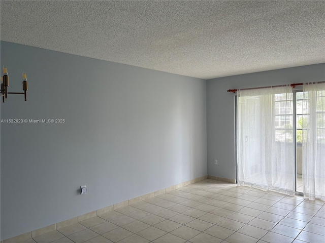 12755 SW 16th Ct Unit 211B, Pembroke Pines, FL 33027 - spare room featuring a textured ceiling and tile patterned floors