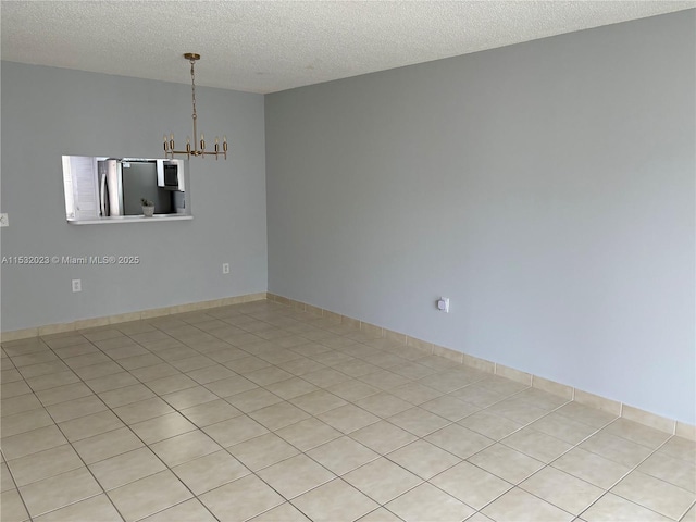 12755 SW 16th Ct Unit 211B, Pembroke Pines, FL 33027 - spare room featuring a chandelier and a textured ceiling