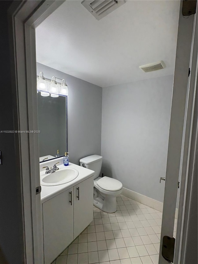 12755 SW 16th Ct Unit 211B, Pembroke Pines, FL 33027 - half bathroom with vanity, toilet, tile patterned floors, and baseboards