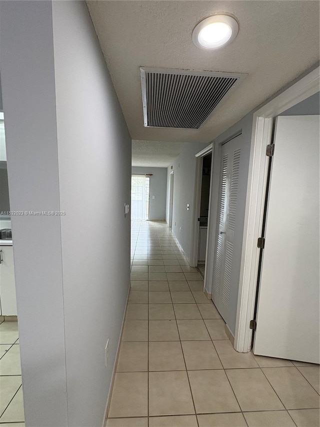 12755 SW 16th Ct Unit 211B, Pembroke Pines, FL 33027 - hall featuring light tile patterned flooring and baseboards