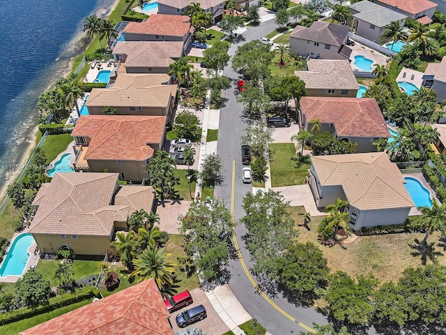 bird's eye view with a water view and a residential view