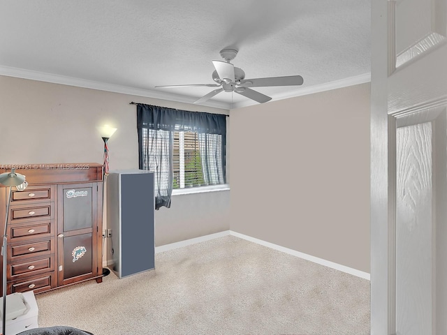 unfurnished bedroom with a textured ceiling, baseboards, a ceiling fan, and crown molding