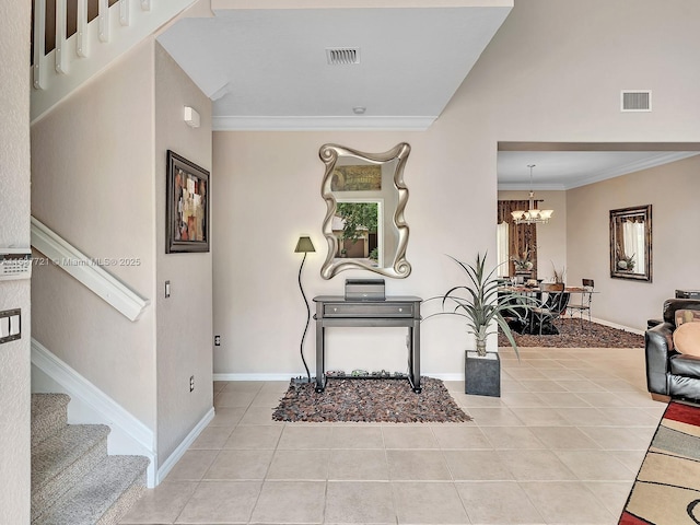 entrance foyer with light tile patterned floors, stairway, visible vents, and crown molding