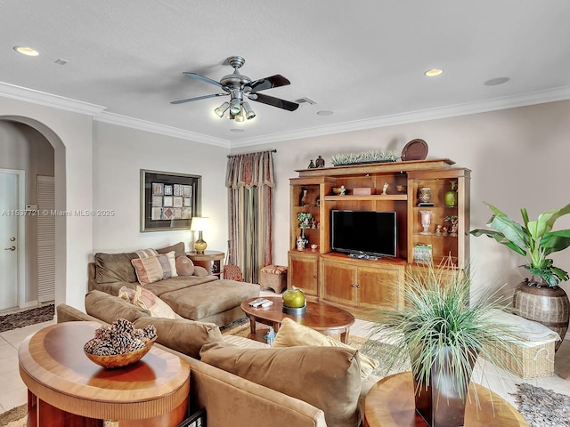 living area with arched walkways, ceiling fan, tile patterned flooring, crown molding, and recessed lighting