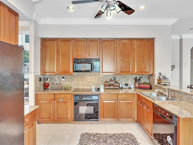 kitchen with light stone counters, ornamental molding, a sink, black appliances, and backsplash