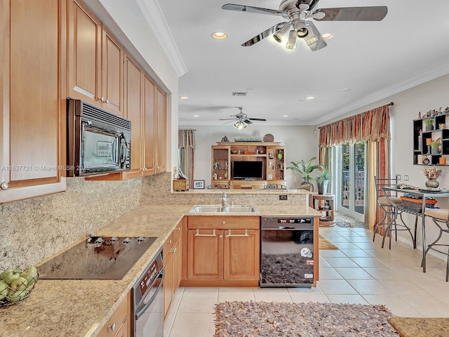 kitchen featuring light tile patterned floors, a peninsula, a sink, black appliances, and crown molding