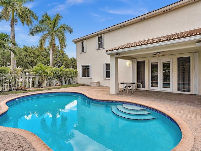 view of swimming pool featuring a fenced in pool, a ceiling fan, fence, french doors, and a patio area